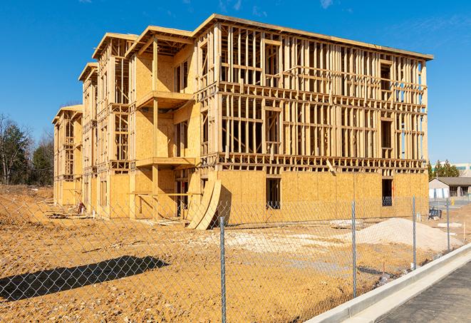 a close-up of temporary chain link fences enclosing a construction site, signaling progress in the project's development in Scottsdale